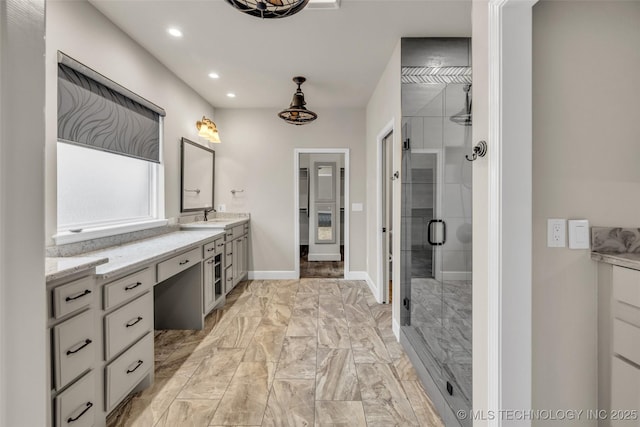 bathroom featuring vanity and a shower with shower door