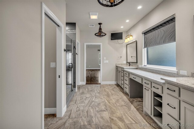 bathroom featuring vanity and an enclosed shower