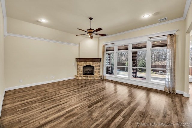 unfurnished living room featuring ceiling fan, ornamental molding, a fireplace, and dark wood-type flooring