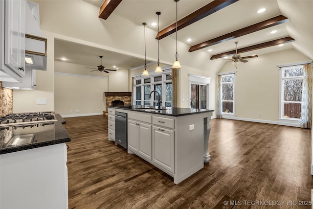 kitchen featuring white cabinetry, sink, ceiling fan, and a center island with sink