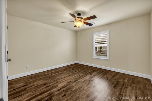 spare room with ceiling fan and dark wood-type flooring