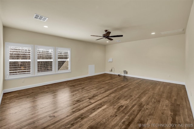 spare room with dark hardwood / wood-style floors and ceiling fan