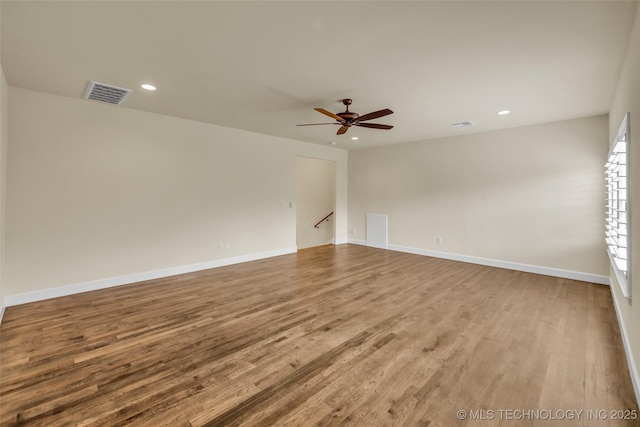 spare room featuring hardwood / wood-style floors and ceiling fan