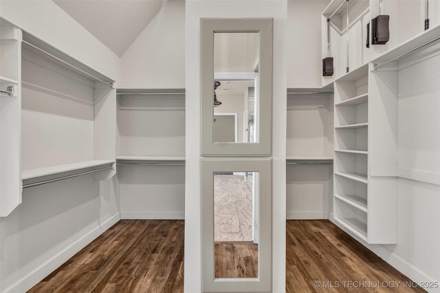 12050 S 68th E Ave E, Bixby, OK 74008 - spacious closet featuring dark wood-type flooring and vaulted ceiling