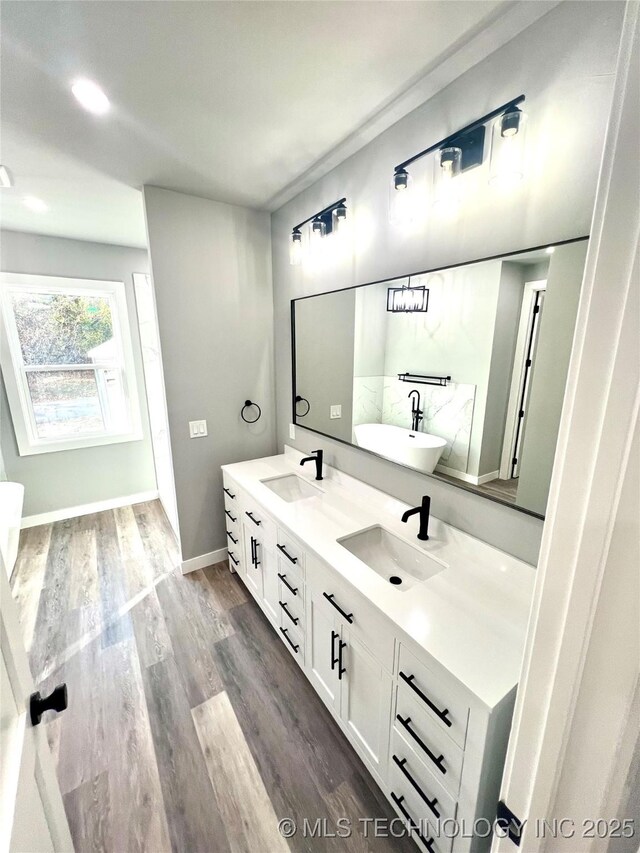 bathroom with vanity and hardwood / wood-style flooring