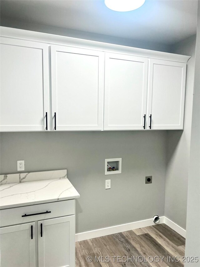 laundry area with washer hookup, electric dryer hookup, cabinets, and hardwood / wood-style floors