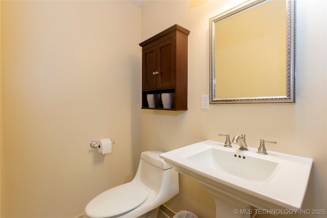 bathroom with toilet and sink