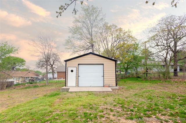 garage at dusk with a yard