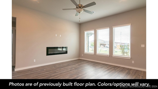 empty room featuring ceiling fan and dark wood-type flooring