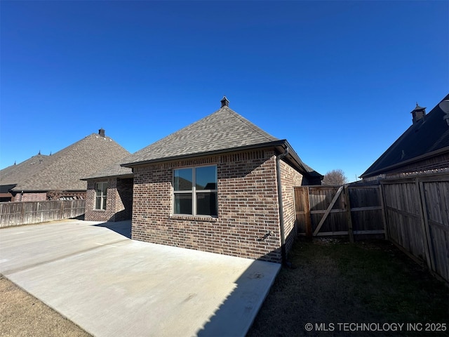 back of property featuring a patio