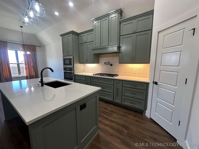 kitchen featuring backsplash, sink, decorative light fixtures, light stone counters, and stainless steel appliances