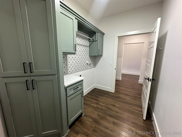 laundry room featuring cabinets and dark hardwood / wood-style flooring