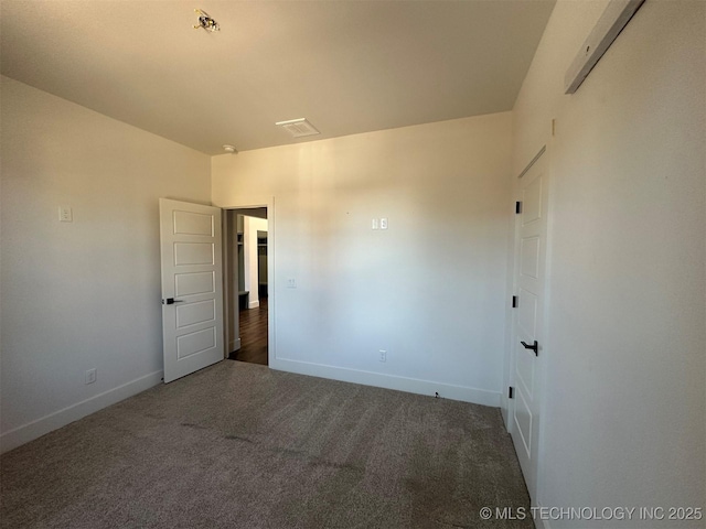 unfurnished room with dark carpet