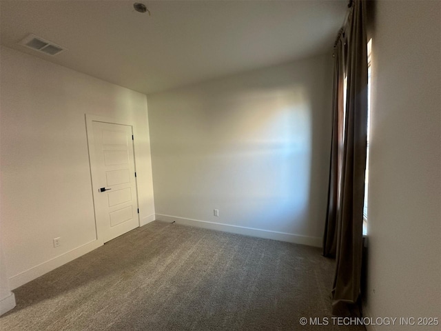 empty room with dark colored carpet