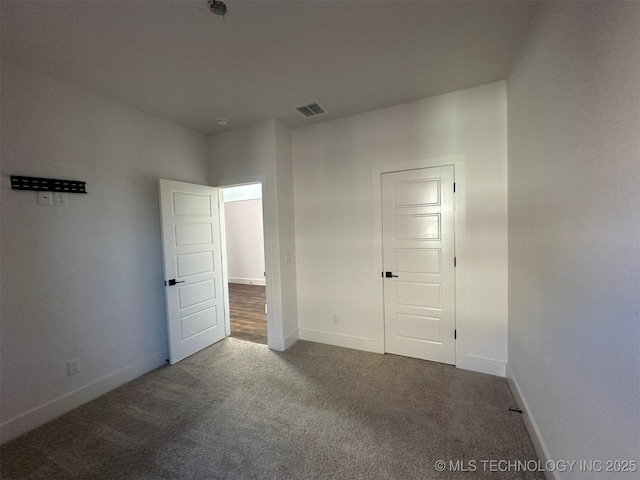 unfurnished bedroom featuring carpet flooring and a closet