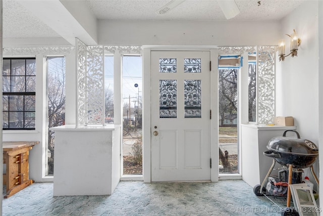 sunroom / solarium featuring a healthy amount of sunlight