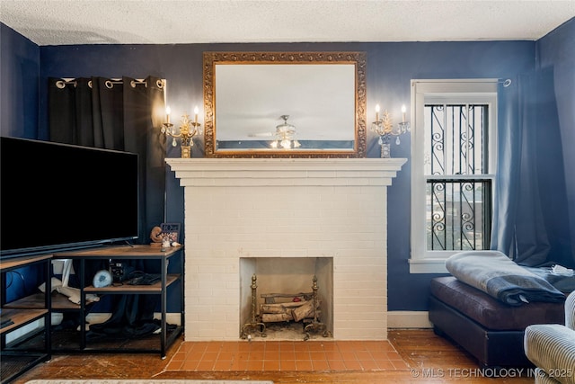 living room with ceiling fan, a textured ceiling, and a brick fireplace