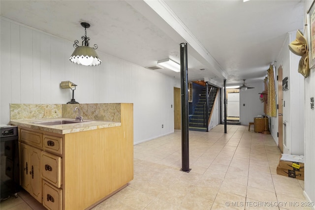 interior space with ceiling fan and sink