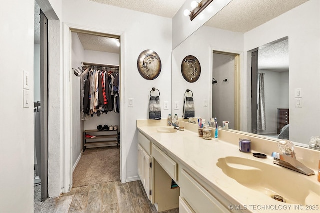 bathroom featuring a textured ceiling and vanity