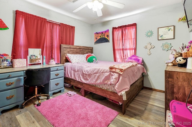 bedroom with light hardwood / wood-style floors and ceiling fan