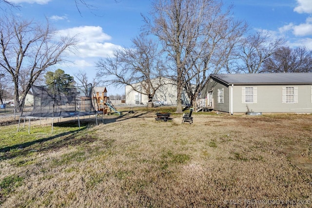 view of yard featuring a playground and a trampoline