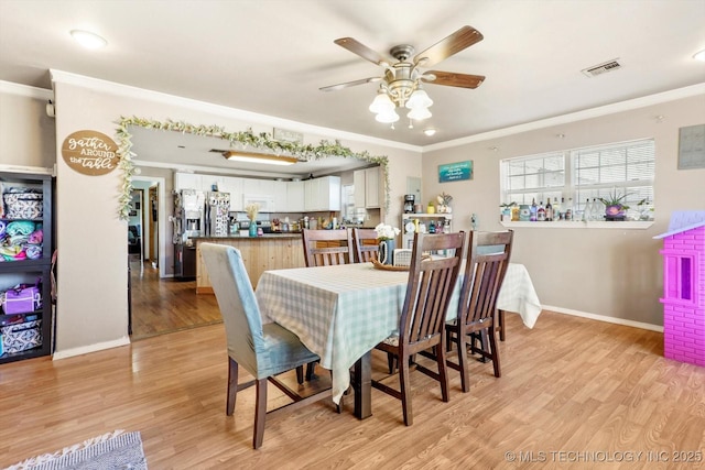 dining room with ceiling fan, light hardwood / wood-style floors, and ornamental molding