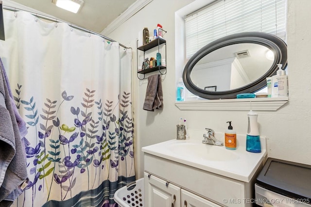 bathroom featuring vanity and ornamental molding