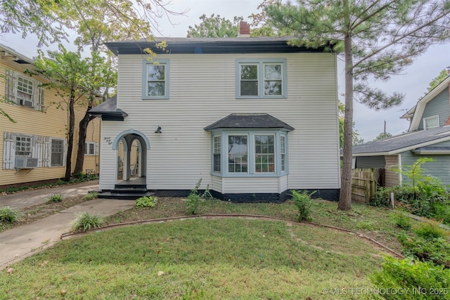 view of front of home featuring cooling unit, a front yard, and french doors