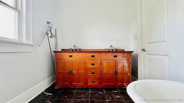 bathroom featuring a bath and sink