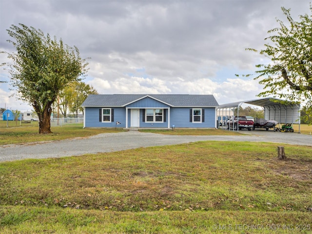 ranch-style house featuring a front yard and a carport