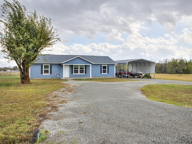 single story home featuring a front lawn and a carport