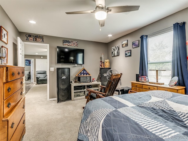 bedroom featuring light colored carpet and ceiling fan