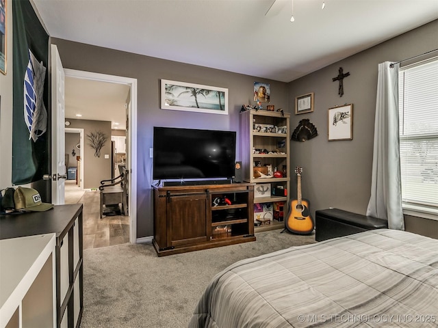 bedroom with multiple windows, light carpet, and ceiling fan