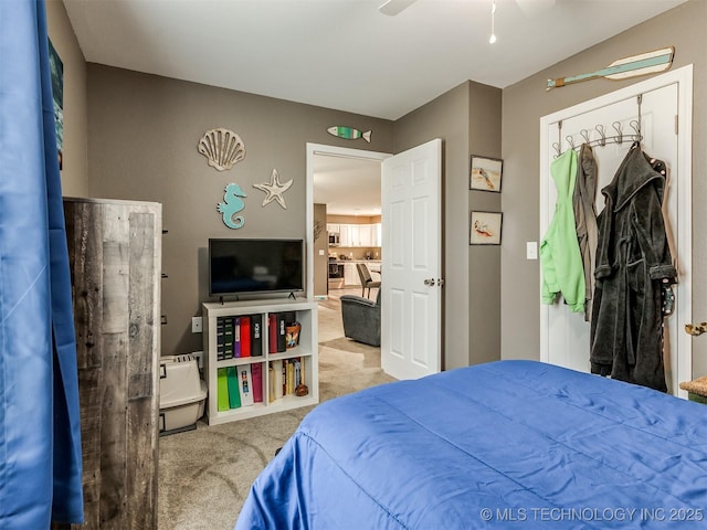 carpeted bedroom featuring ceiling fan