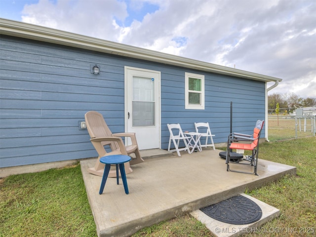 rear view of house with a yard and a patio