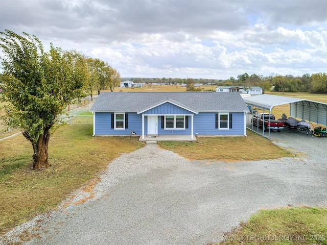 ranch-style house with a front yard, a porch, and a carport