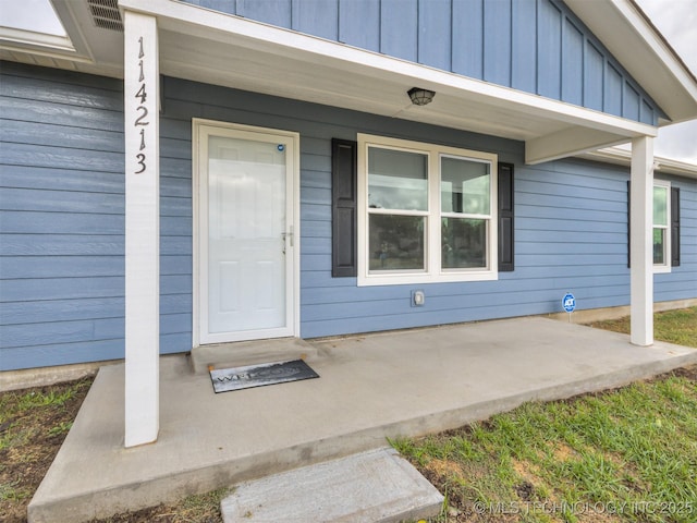 property entrance featuring covered porch