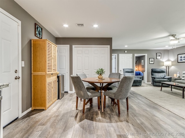 dining room featuring light wood-type flooring and ceiling fan