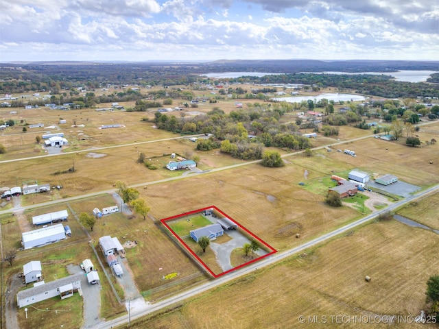 birds eye view of property featuring a water view and a rural view