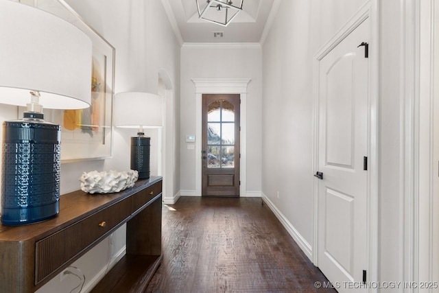 doorway featuring dark wood-style flooring, visible vents, crown molding, and baseboards