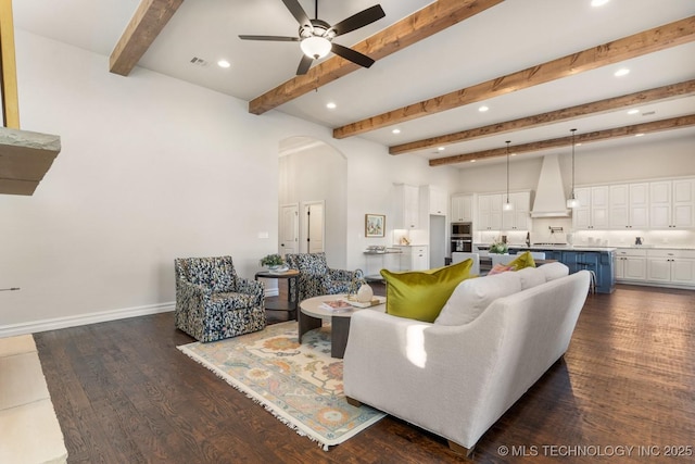 3913 S Dogwood Blvd, Broken Arrow, OK 74012 - living room with arched walkways, a ceiling fan, baseboards, beam ceiling, and dark wood finished floors