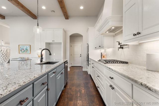 3913 S Dogwood Blvd, Broken Arrow, OK 74012 - kitchen with light stone counters, a sink, white cabinetry, hanging light fixtures, and custom range hood