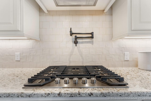 3913 S Dogwood Blvd, Broken Arrow, OK 74012 - room details featuring white cabinetry, stainless steel gas cooktop, decorative backsplash, and light stone counters