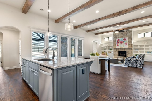3913 S Dogwood Blvd, Broken Arrow, OK 74012 - kitchen featuring light stone counters, open floor plan, decorative light fixtures, a kitchen island with sink, and a sink