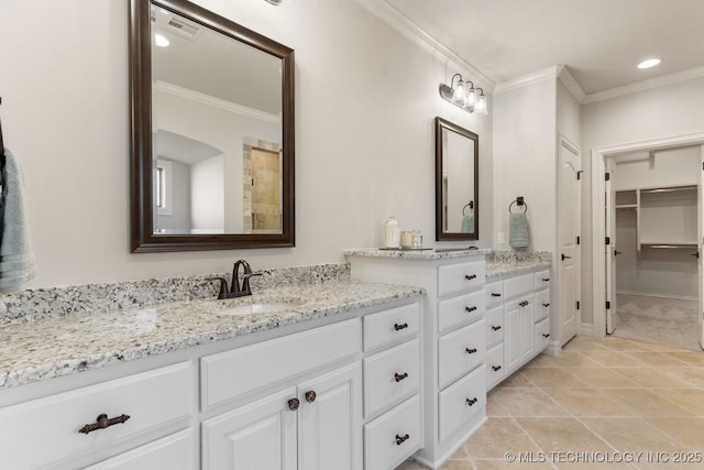 3913 S Dogwood Blvd, Broken Arrow, OK 74012 - full bathroom featuring visible vents, ornamental molding, a walk in closet, and vanity