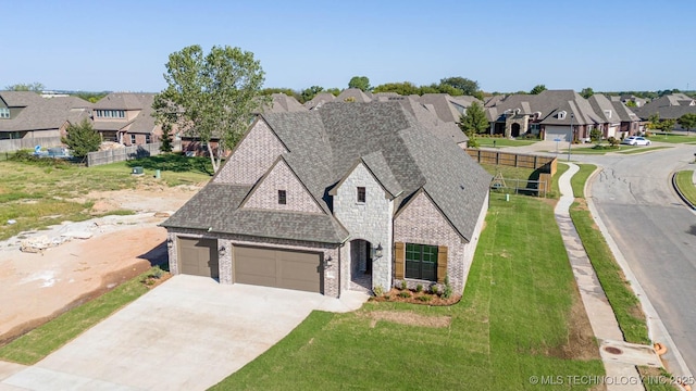 view of front of house featuring a garage and a front lawn