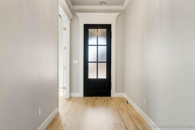 doorway to outside with light hardwood / wood-style floors and ornamental molding