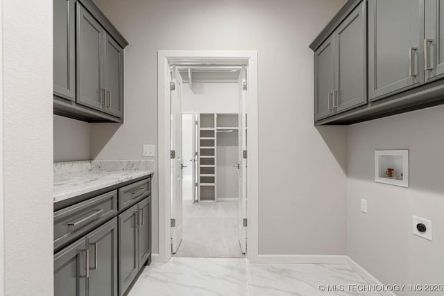 clothes washing area with cabinets, washer hookup, and hookup for an electric dryer