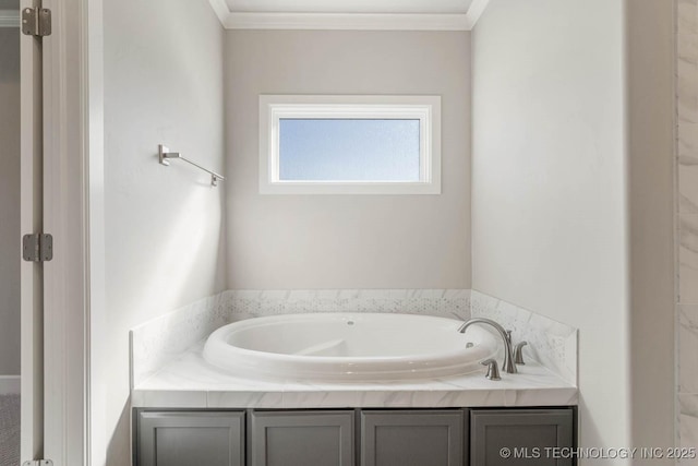 bathroom featuring crown molding and a tub