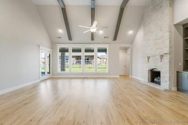 unfurnished living room featuring ceiling fan, a fireplace, high vaulted ceiling, and beamed ceiling